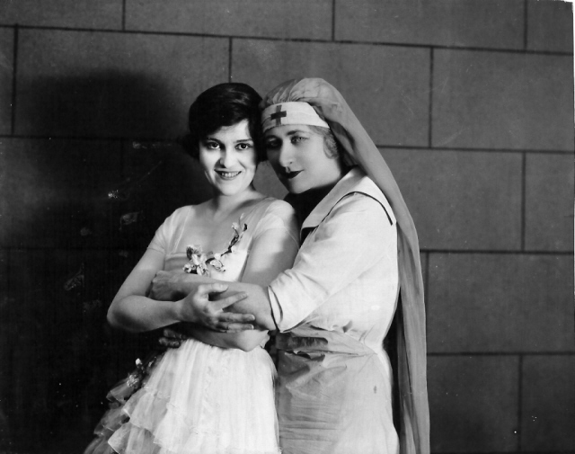 Pals, they call Mary Garden and Madge Kennedy at the Goldwyn Studio, where the singer has just completed her newest motion picture, which she calls "a gorgeous thing". Here she is seen on the last day of her studio work on this production saying au revoir to the piquant Madge Kennedy and telling her that sh'd give a fortune for her eyes and smile. Mary Garden is soon to be seen in her newest picture "The Splendid Sinner."